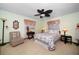 A cozy bedroom featuring a floral patterned comforter and neutral-colored walls for relaxation at 1799 Dixie Hwy, Tarpon Springs, FL 34689