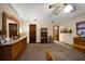 A bedroom with a ceiling fan, a dresser, and multiple doorways, offering space and convenience at 1799 Dixie Hwy, Tarpon Springs, FL 34689