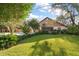 Charming exterior view of the well-manicured front yard with mature trees and appealing landscaping at 1799 Dixie Hwy, Tarpon Springs, FL 34689