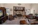 Cozy living area with a stone fireplace, comfortable seating, and natural light at 1799 Dixie Hwy, Tarpon Springs, FL 34689