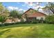 Charming home featuring lush landscaping, a well-manicured lawn, and a unique wood exterior at 1799 Dixie Hwy, Tarpon Springs, FL 34689