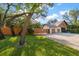 Landscaped front yard featuring a well-maintained lawn and a charming wood fence at 1799 Dixie Hwy, Tarpon Springs, FL 34689