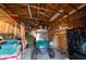 View of a spacious wooden garage featuring a golf cart and offering ample storage solutions at 1799 Dixie Hwy, Tarpon Springs, FL 34689