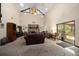 Bright living room with a vaulted ceiling, stone fireplace, and sliding glass doors at 1799 Dixie Hwy, Tarpon Springs, FL 34689