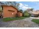 Exterior view of an outbuilding with a gravel driveway and a well-maintained yard at 1799 Dixie Hwy, Tarpon Springs, FL 34689