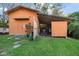 Exterior view of an outbuilding with a well-maintained yard and a gravel driveway at 1799 Dixie Hwy, Tarpon Springs, FL 34689
