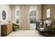 Bedroom design featuring a crib, comfortable chair, and dresser for a serene atmosphere at 18136 Serene Lake Loop, Lutz, FL 33548