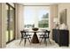 Bright dining room featuring a round table, four chairs, and large windows with a view at 18136 Serene Lake Loop, Lutz, FL 33548