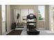 Home gym featuring a treadmill, mirror, and weight rack for a complete workout space at 18136 Serene Lake Loop, Lutz, FL 33548