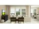 Stylish living room featuring modern seating, neutral tones, and natural light from large windows at 18136 Serene Lake Loop, Lutz, FL 33548