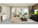 Comfortable living room with a sectional sofa, stylish decor, and a view of the neighborhood at 18136 Serene Lake Loop, Lutz, FL 33548