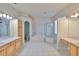 Bright bathroom featuring a soaking tub, walk-in shower and dual vanities at 18444 Eastwyck Dr, Tampa, FL 33647