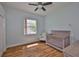 Bedroom features a window, hardwood floors, a closet, and a crib at 18444 Eastwyck Dr, Tampa, FL 33647