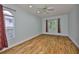 Light-filled bedroom featuring hardwood floors and a window overlooking the outdoor scenery at 18444 Eastwyck Dr, Tampa, FL 33647