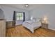 Bedroom features a ceiling fan, hardwood floors, and a window letting in natural light at 18444 Eastwyck Dr, Tampa, FL 33647