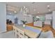 Dining area with modern table, chandelier, and view of kitchen with island and stainless appliances at 18444 Eastwyck Dr, Tampa, FL 33647
