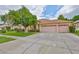 Spacious one-story home featuring a well-maintained lawn, and a driveway leading to a three-car garage at 18444 Eastwyck Dr, Tampa, FL 33647