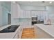 Well-equipped kitchen featuring white cabinets, stainless steel appliances, and a modern cooktop at 18444 Eastwyck Dr, Tampa, FL 33647