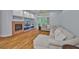 Bright living room featuring a fireplace, custom built-ins, and expansive windows at 18444 Eastwyck Dr, Tampa, FL 33647