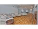 Bright living room with hardwood floors and view into the kitchen, fireplace, and open floorplan at 18444 Eastwyck Dr, Tampa, FL 33647