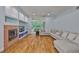 Well-lit living room boasting a fireplace, built-in shelving, and view to the outside patio at 18444 Eastwyck Dr, Tampa, FL 33647