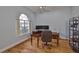 Bright office with hardwood floors, a large window, and a traditional desk setup at 18444 Eastwyck Dr, Tampa, FL 33647