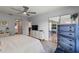 Light and airy bedroom with ceiling fan, white dresser, blue accents, and sliding glass doors to a patio at 19029 Us Highway 19 N # 5-16, Clearwater, FL 33764