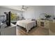 Bedroom features a large window for natural light, ceiling fan, dresser and wood floors at 19029 Us Highway 19 N # 5-16, Clearwater, FL 33764
