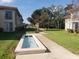 Well-maintained courtyard with a decorative water feature and lush greenery between buildings at 19029 Us Highway 19 N # 5-16, Clearwater, FL 33764