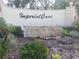 Inviting entrance sign for Imperial Cove surrounded by lush tropical landscaping at 19029 Us Highway 19 N # 5-16, Clearwater, FL 33764