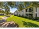 Well-maintained condo building with lush landscaping and mature trees at 19029 Us Highway 19 N # 5-16, Clearwater, FL 33764