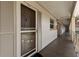 Hallway view of the condo entrance with unit number and beige exterior wall at 19029 Us Highway 19 N # 5-16, Clearwater, FL 33764