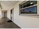 Exterior hallway view showing condo window and entrance door at 19029 Us Highway 19 N # 5-16, Clearwater, FL 33764