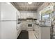 Bright kitchen featuring white cabinets and appliances and decorative backsplash at 19029 Us Highway 19 N # 5-16, Clearwater, FL 33764