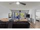 Living room features wood floors, ceiling fan and sliding glass doors to porch at 19029 Us Highway 19 N # 5-16, Clearwater, FL 33764