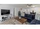Spacious living room features a stylish sofa, wood floors and TV at 19029 Us Highway 19 N # 5-16, Clearwater, FL 33764