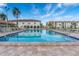 Resort-style community pool with lounge chairs and tropical landscaping at 19029 Us Highway 19 N # 5-16, Clearwater, FL 33764