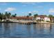 Tranquil water view showcasing the community's waterfront amenities and buildings with tile roofs at 19029 Us Highway 19 N # 5-16, Clearwater, FL 33764