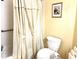 Standard bathroom features a shower/tub combo with tiled walls and a neutral tone shower curtain at 19420 Haskell Pl, Land O Lakes, FL 34638