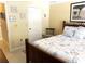Bedroom showcasing a quaint chair, beach themed wall art, and inviting linens on the comfortable bed at 19420 Haskell Pl, Land O Lakes, FL 34638