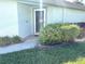 Inviting front entrance with beautifully landscaped garden featuring lush green bushes and an accent walkway at 19420 Haskell Pl, Land O Lakes, FL 34638