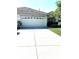 Charming home featuring a well-maintained two-car garage and extended driveway with manicured lawn at 19420 Haskell Pl, Land O Lakes, FL 34638