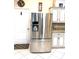 Stainless steel French door refrigerator in a well-appointed kitchen with tiled floors and updated appliances at 19420 Haskell Pl, Land O Lakes, FL 34638