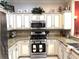 Well-equipped kitchen with stainless steel appliances, granite countertops, and ample cabinet space at 19420 Haskell Pl, Land O Lakes, FL 34638