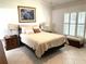 Relaxing main bedroom with neutral tones, plantation shutters, and decorative accents at 19420 Haskell Pl, Land O Lakes, FL 34638