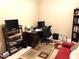 Well-lit home office featuring a desk, shelving, and comfortable seating area at 19420 Haskell Pl, Land O Lakes, FL 34638