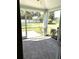This patio offers a serene view of the backyard, enclosed by a screened frame, and accessible with glass paned doors at 19420 Haskell Pl, Land O Lakes, FL 34638