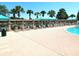 Community swimming pool area with lounge chairs and shade canopies for a relaxing outdoor experience at 19420 Haskell Pl, Land O Lakes, FL 34638