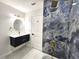 Bathroom features modern vanity with gold fixtures and blue marble tiled shower with rainfall shower head at 21033 Market St, Dade City, FL 33523