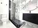 Modern bathroom features walk-in shower with black hardware and floating vanity at 21033 Market St, Dade City, FL 33523